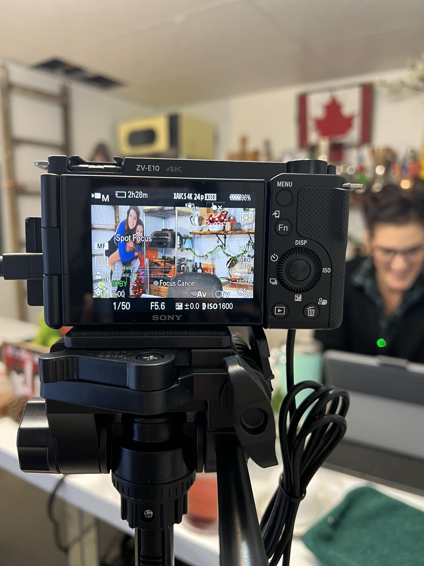 Sony ZV-E10 camera showing live preview of the cooking show host on screen